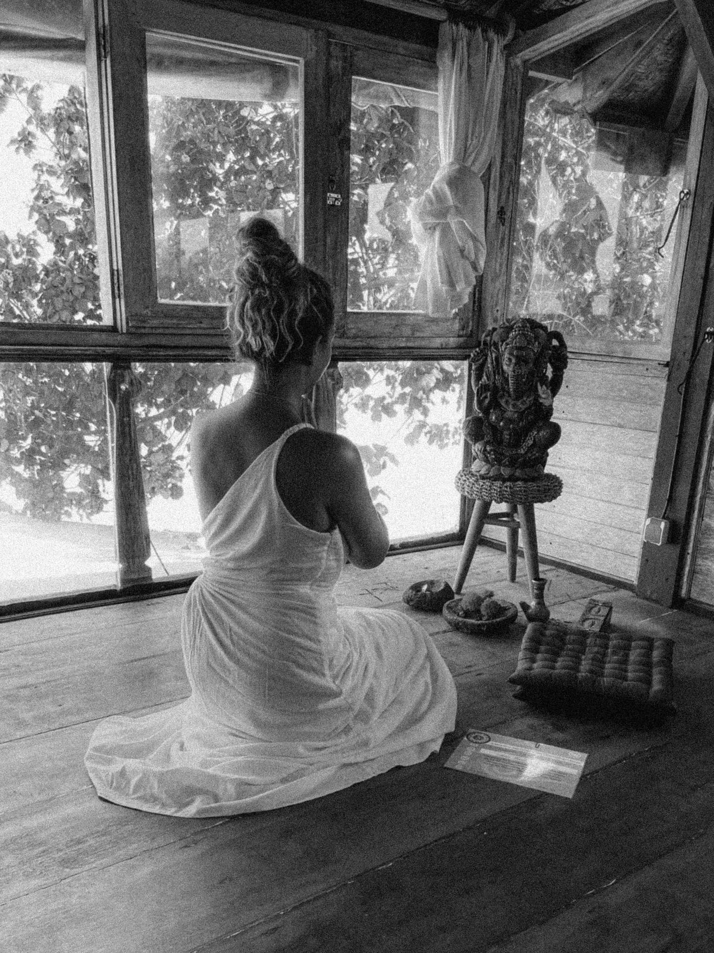Sitting in quiet practice beside a small altar by the window